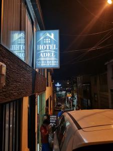 a hotel adel sign on the side of a building at Hotel Adel in Manizales