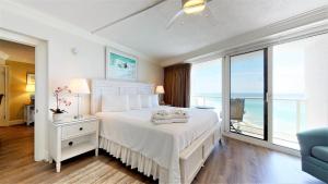 een slaapkamer met een wit bed en uitzicht op de oceaan bij Beachside II 4351 in Destin