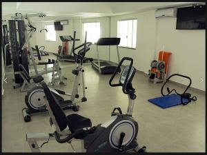 a gym with several treadmills and exercise bikes at Hotel Sollievo in Irati
