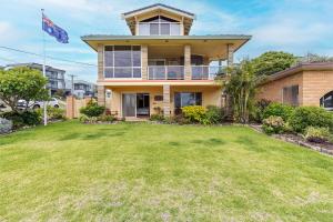 a house with a large yard in front of it at Anchored at Fingal Bay 80 Marine Drive in Fingal Bay