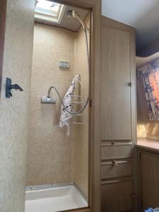 a bathroom with a shower and a bath tub at Back Beach Retro Van in Fingal