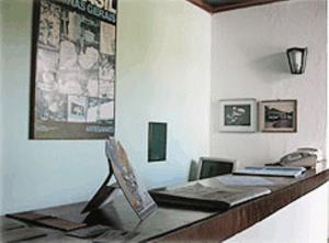 a office with a desk with a phone at Hotel Pousada Hospedaria Antiga in Ouro Preto +49 photos