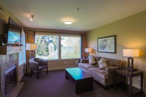 a living room with a couch and a window at Pacific Shores Resort & Spa in Parksville