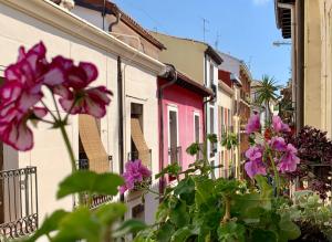 a row of houses with purple flowers in front of them at Logroño Best Choice Apartament in Logroño