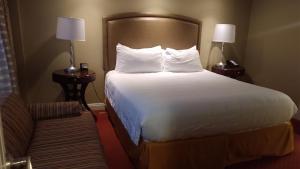 a hotel room with a large bed and a couch at Suites at Jockey Club (No Resort Fee) in Las Vegas
