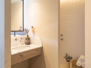 a bathroom with a sink and a mirror at Mercure Benidorm in Benidorm