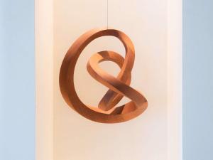 a wooden peace sign hanging on a wall at Mercure Benidorm in Benidorm