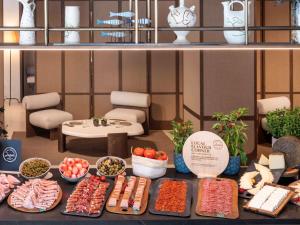 a table with different types of food on it at Mercure Benidorm in Benidorm