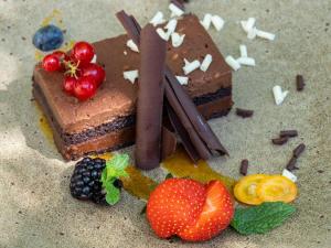 a piece of chocolate cake and strawberries on the table at Mercure Benidorm in Benidorm