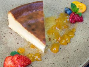a piece of cake with fruit on a plate at Mercure Benidorm in Benidorm