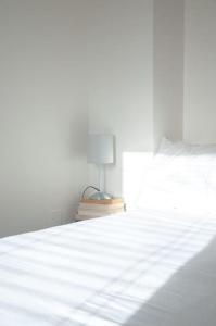 a bedroom with a white bed with a lamp on it at 2 bed 2 bath Apartment with Canal View in Dublin