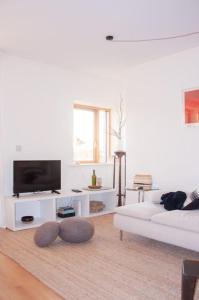 a white living room with a white couch and a tv at 2 bed 2 bath Apartment with Canal View in Dublin