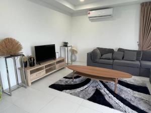 a living room with a couch and a coffee table at Apartment in Kuching in Kuching