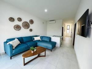 een woonkamer met een blauwe bank en een tafel bij Estrella del mar · Hermosa casa vacacional in Barrón