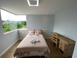 a bedroom with a bed with two teddy bears on it at Casa de praia in Paraty