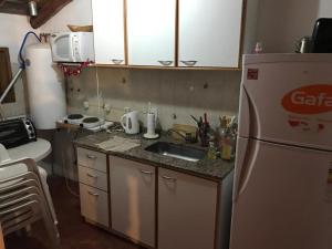 a small kitchen with a sink and a refrigerator at Solares de Cacheuta in Cacheuta