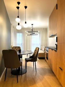 a kitchen and dining room with a table and chairs at Lovely Apartment in Krakow