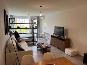a living room with a couch and a flat screen tv at Apartamento nuevo en Congreso- amplio- vista inigualable in Buenos Aires