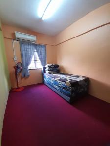 a small room with a bed and a window at Dhuha Homestay @ Seri Alam Masai , Johor in Masai