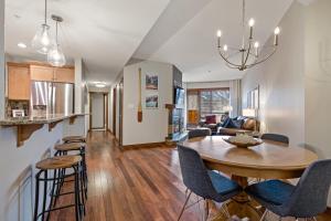 a dining room and living room with a table and chairs at RidgeView Loft - Top Floor 2 Bed 2 Bath, Amazing Views in Canmore