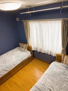 a bedroom with two beds and a window at Okhotsk House Shari in Shari