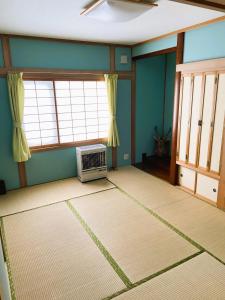 a living room with a toaster oven on the floor at Okhotsk House Shari in Shari
