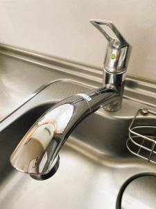 a chrome sink faucet on a kitchen sink at Okhotsk House Shari in Shari