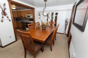 a dining room with a wooden table and chairs at Cozy Seven Springs 1 Bedroom Condo with Private Deck condo in Champion