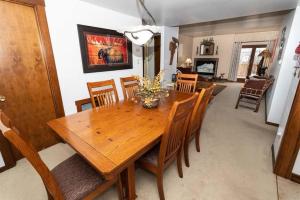 a dining room with a wooden table and chairs at Cozy Seven Springs 1 Bedroom Condo with Private Deck condo in Champion