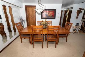 a dining room with a wooden table and chairs at Cozy Seven Springs 1 Bedroom Condo with Private Deck condo in Champion