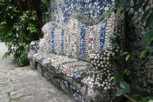 a blue and white bench sitting in the middle of a garden at Pousada Barroco na Bahia in Salvador