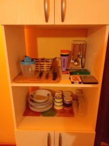 a cupboard with plates and dishes on it at El Sauce de las Vegas in Cobquecura