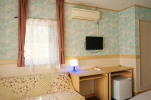 sypialnia z łóżkiem, biurkiem i oknem w obiekcie Klingelbaer w mieście Hakone