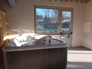 トーディにあるDeluxe Apartment in Todi with Swimming Poolの窓付きの客室で、バスタブが備わります。