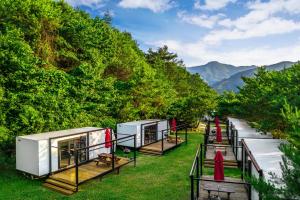 a row of tiny houses on the side of a river at Club Lespia Namyangju 2nd Branch in Namyangju