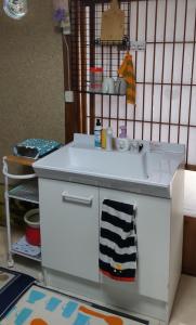 a toy kitchen with a sink in a room at Guesthouse Yashima in Takamatsu