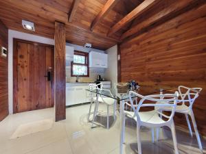 a kitchen with wooden walls and a table and chairs at Destinar Apartments in San Carlos de Bariloche