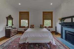 a bedroom with a bed and a fireplace at Oak Hall Bed and Breakfast in Vicksburg