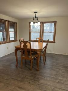 a dining room with a wooden table and chairs at A charm Cape house centrally located close to everything that Cape code offers in Yarmouth