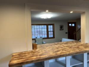 a kitchen with a wooden counter top in a room at A charm Cape house centrally located close to everything that Cape code offers in Yarmouth