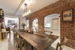 a kitchen and dining room with a brick wall at NYC Duplex & Private garden Oasis!! in New York