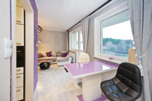 a room with a purple desk and a window at YOURAPART Gdansk Morena in Gdańsk