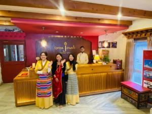 a group of people standing in front of a restaurant at Three Jewels Boutique Hotel in Pokhara