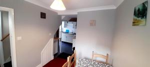 a room with a kitchen and a dining room at Penzance Cottage in Penzance