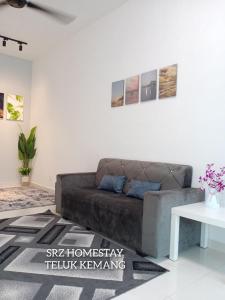 a living room with a couch and a table at Srz Homestay Teluk Kemang PD in Port Dickson