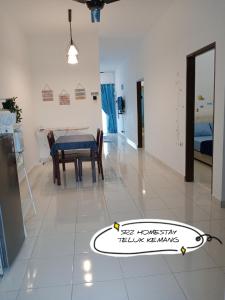 a room with a table and a dining room at Srz Homestay Teluk Kemang PD in Port Dickson