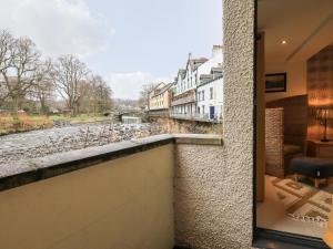 a balcony with a view of a river and buildings at Riverside Park 2 in Keswick