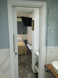a bathroom with a bed and a television in a room at Lapa Bed & Breakfast in Rio de Janeiro