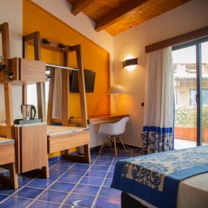 una camera d'albergo con letto e scrivania di Magaggiari Hotel Resort a Cinisi