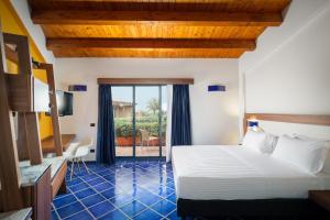 Postel nebo postele na pokoji v ubytování Magaggiari Hotel Resort